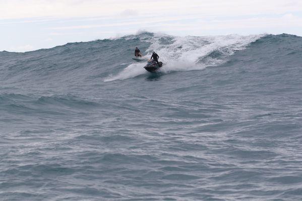 Tow in session at an outer reef on the north shore