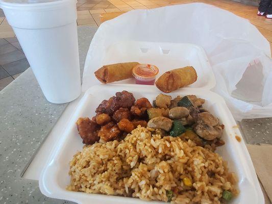 Pork egg roll and fried rice with orange chicken and chicken with mushrooms