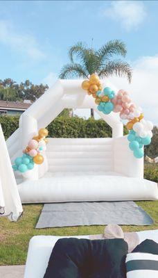 "Double Dipper" white bounce house with a 20ft balloon garland.