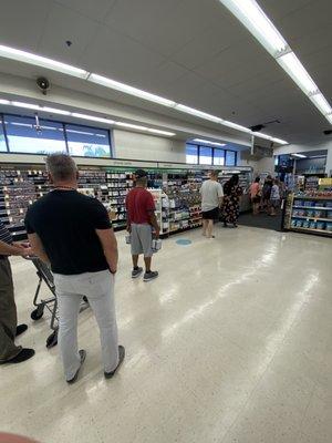 Typical long line and one cashier.