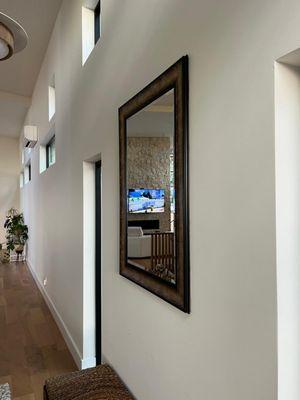 A beautiful mirror installed on the hallway.