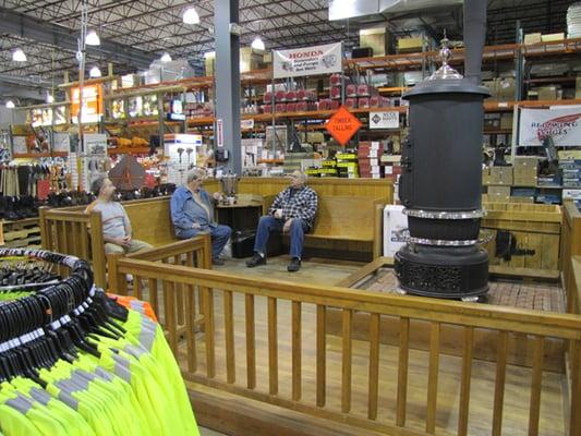 Customers enjoying a cup of coffee and a chat around Madsen's antique wood stove.