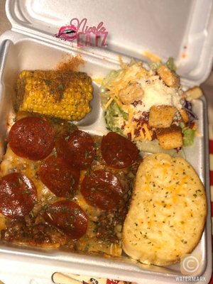 Pepperoni lasagna, cajun corn on the cob, parmesan salad, and cheesy garlic bread.