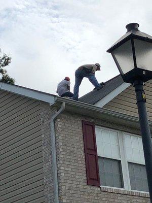 The guys are repairing a GAF Royal Sovereign roof in "Weathered Gray."