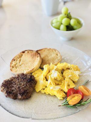 Scrambled eggs with homemade sausage patty and English muffins cooked by our host Rafael - delish!