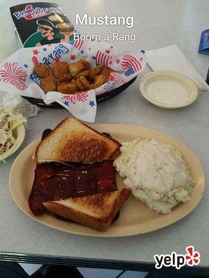 Hot link platter with mashed potatoes and slaw. Fried pickles appetizer.