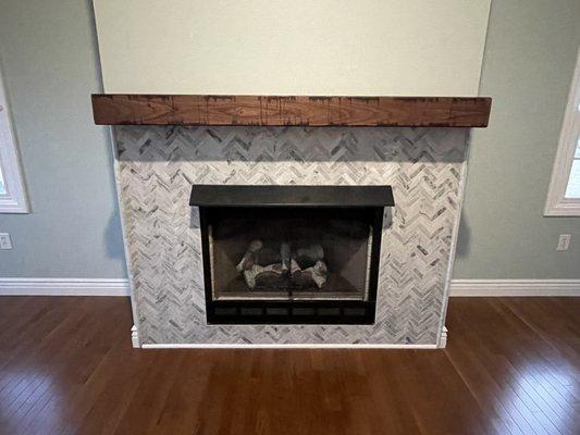 Updating of this family room flooring and fireplace surround with new hardwood floors and herringbone tile