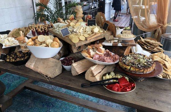 Rustic Charcuterie station set up on a huge pile of firewood. It was a great look.