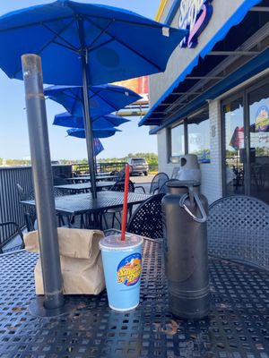 Delicious burger, fries and shake with our pup on the patio