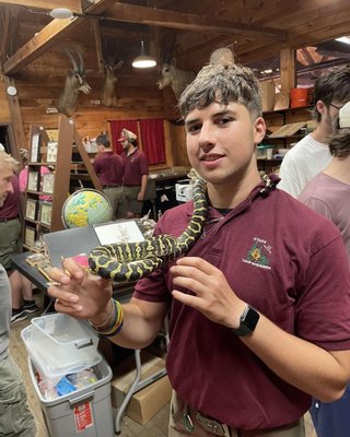 Staff member with snake at the ecology center.