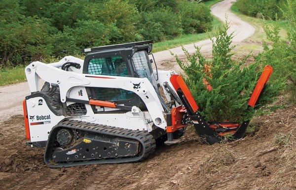 Tree spade attachment makes transplanting trees quick and efficient