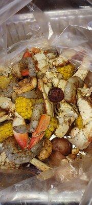 Seafood boil includes, beef polish,sausage,crab,shrimp,scallops,corn, red potatoes, onions, and mushrooms