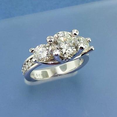 Three stone engagement ring with channel pave diamonds and headlight diamonds! Truly a one of a kind piece!