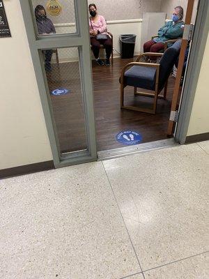 See how close people are seated, and behind the door (out of view) is a homeless person ASLEEP!