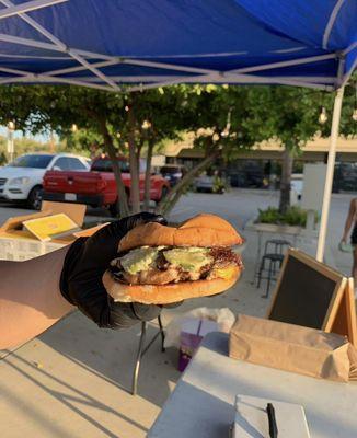 ABC Burger: Double patty with Muenster cheese on a brioche bun topped with carmelized onions, house-made pickles, and ABC sauce.