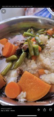 Steak dinner with brown rice and vegetables.