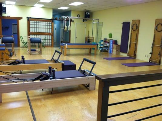 Sprung wooden floors and Balanced Body equipment in the main Pilates room.