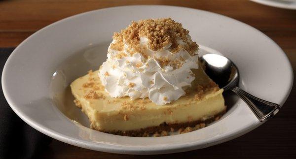 Perfectly tart key lime pie over a graham cracker crust, topped with whipped cream and graham cracker dust.