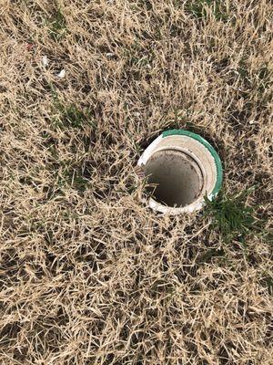 Broken pipe and fragments left on lawn