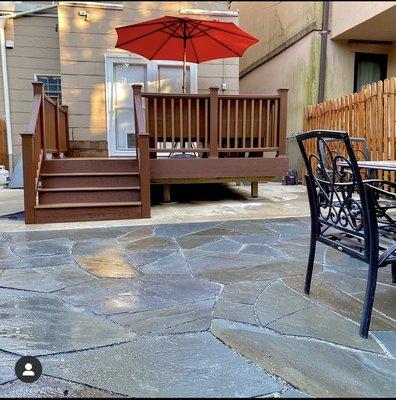 Trex deck with custom bench, irregular bluestone patio with wide joints for drainage, bluestone retaining wall, bluestone steps. Brooklyn,NY