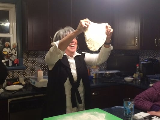 Student stretching pizza dough