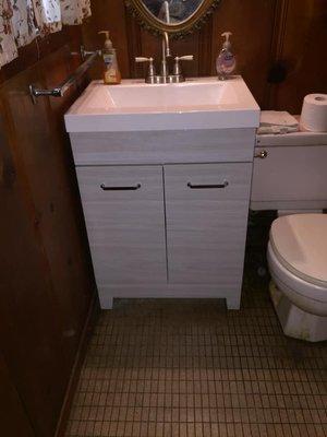 Replaced restroom cabinet, sink and facet fixture