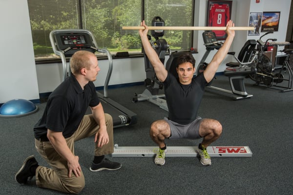 Clinic Director Chad P. at our Columbia physical therapy clinic performing a functional movement screening.