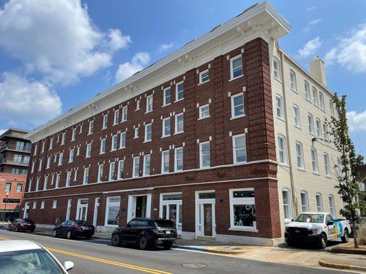 front of a 4-story brick building for sale with NAI Commercial Real Estate