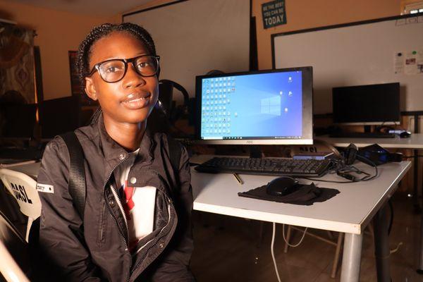 Girl in computer lab receiving training