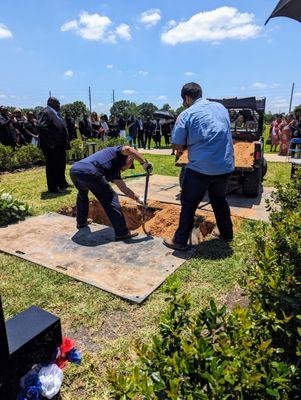 Dignity Memorial employees performing burial.