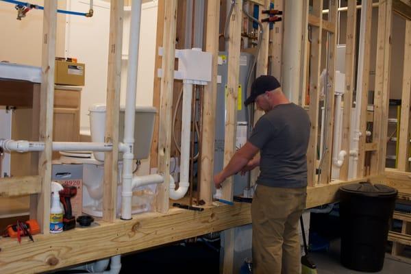 A student learns pipe installation in Total Tech's Plumbing Fundamentals class.