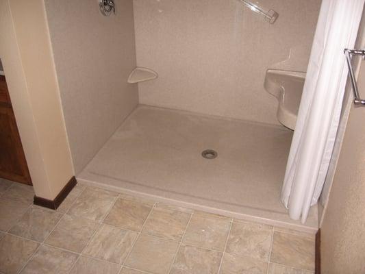 Low profile step over shower base.