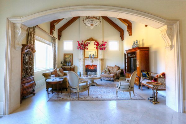 Stunning living space featuring interior cast stone accents and a stone fireplace mantel.