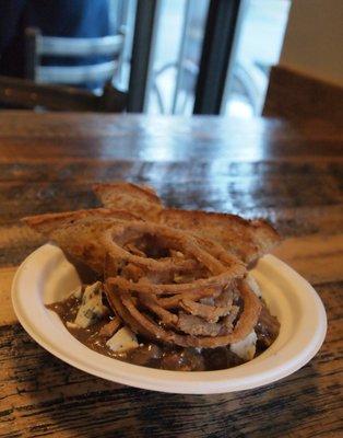 Beef Bourguignon, served with toast, crumbled blue cheese and made-to-order onion rings (from scratch).  Gluten free upon request!