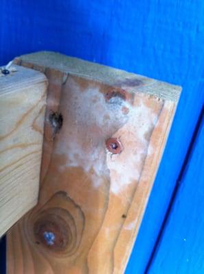 Where deck rail had been drilled into the back of the light switch twice.