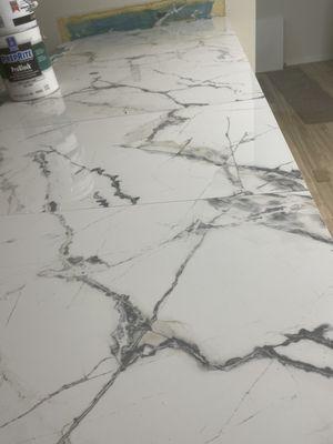 Porcelain oversized tile to give the impression of stone without breaking the bank