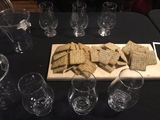 Snacks and glasses lined up to taste Penderyn Whiskey