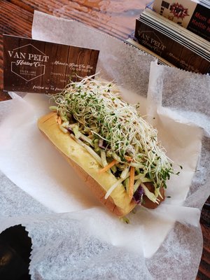 Vegan hot dog with broccoli slaw and sprouts