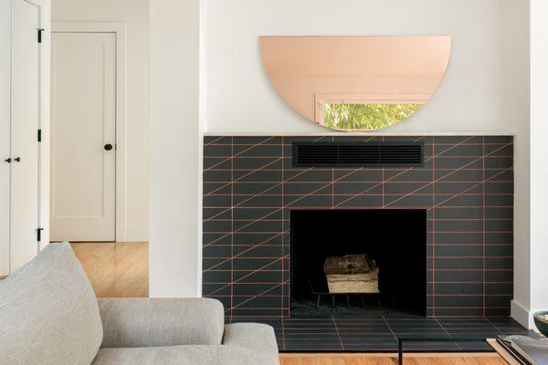 New open layout and custom-designed tile fireplace surround with custom grout color