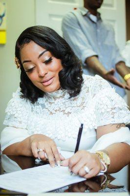 Signing her marriage license.