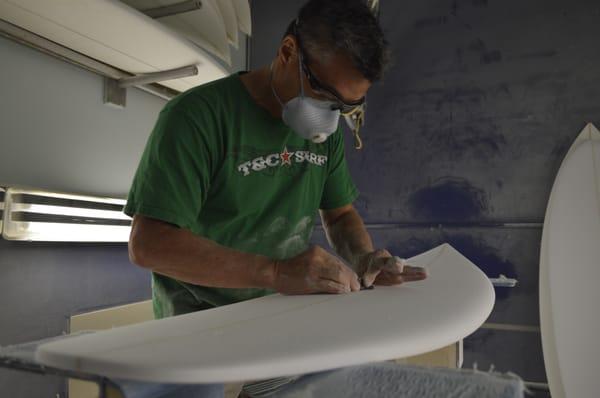 T&C Surfboard shaper Glenn Pang works his magic on a shortboard.