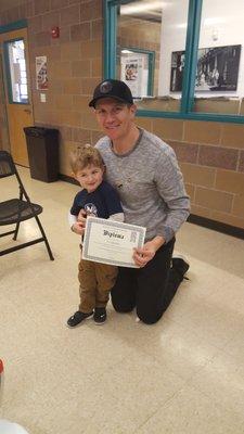 " I did it!" Graduate with proud dad