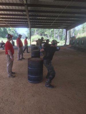 Shooting and moving from cover advancing towards the target.