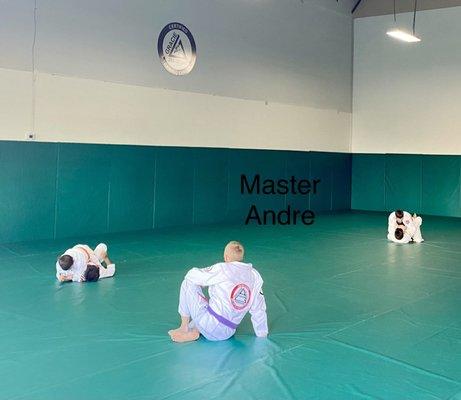 Master André mentoring the kids during a sparring session.