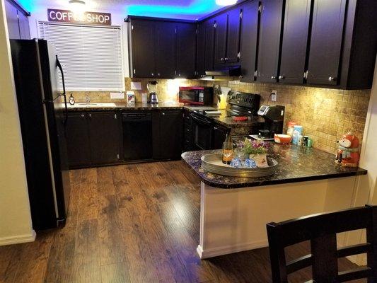 A fully stocked kitchen with toaster, coffee and blender