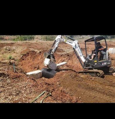 Installing blocks over drainage pipe we installed