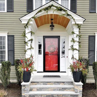 Discover the allure of a welcoming portico, paired with a vibrant door that promises quality and character.