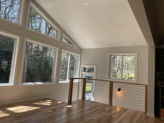 Addition interior with huge bank of windows over looking the water