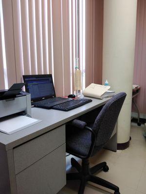 His desk and computer where he compiles his notes