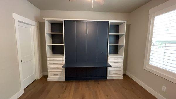 Murphy Bed! This is a Queen size Murphy bed with a desk and built in cabinets to maximize space.